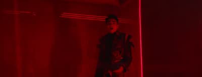 a man standing in front of a red light