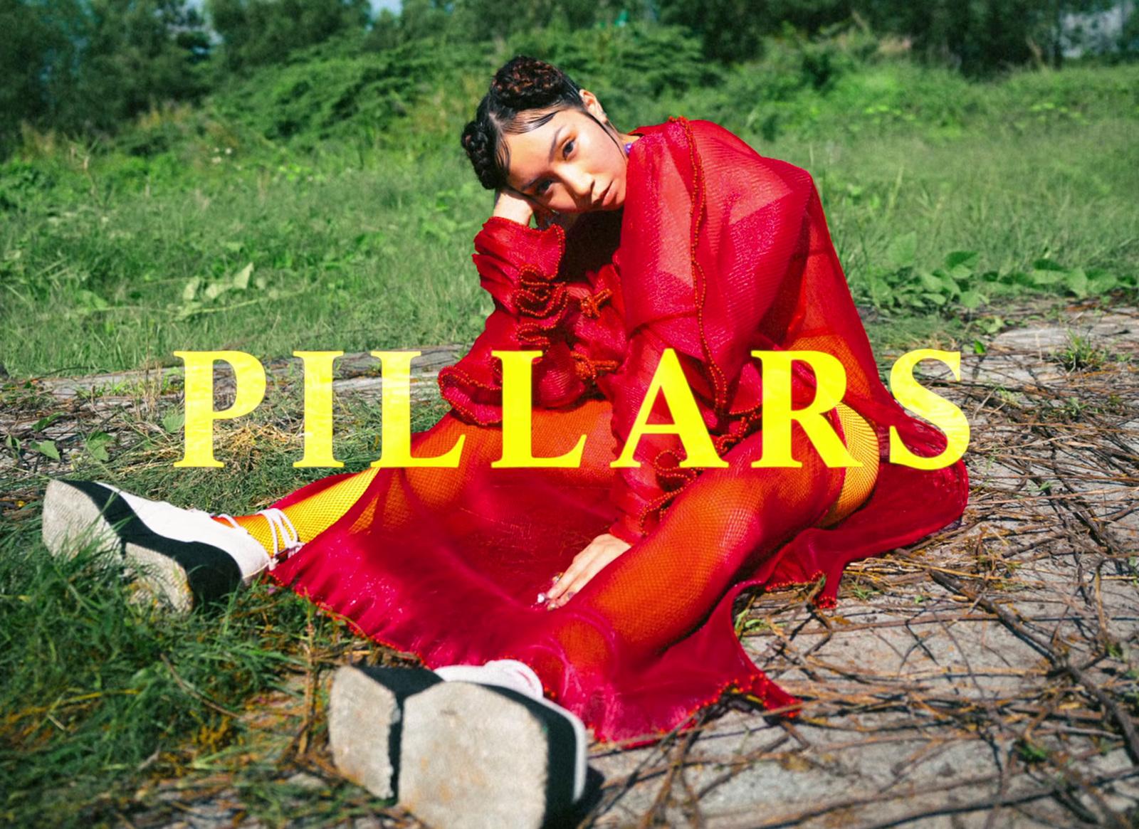 a woman in a red dress sitting on the ground