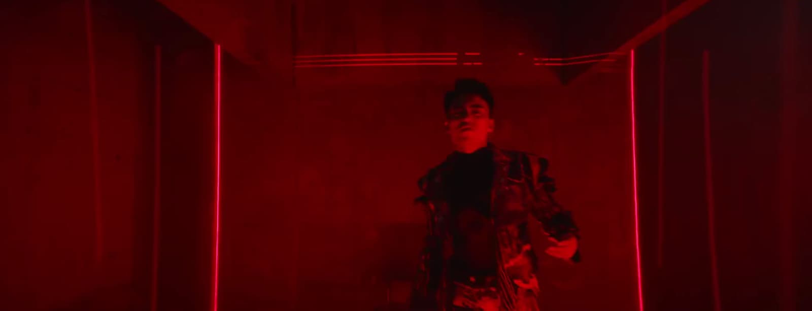 a woman standing in a room with red lights