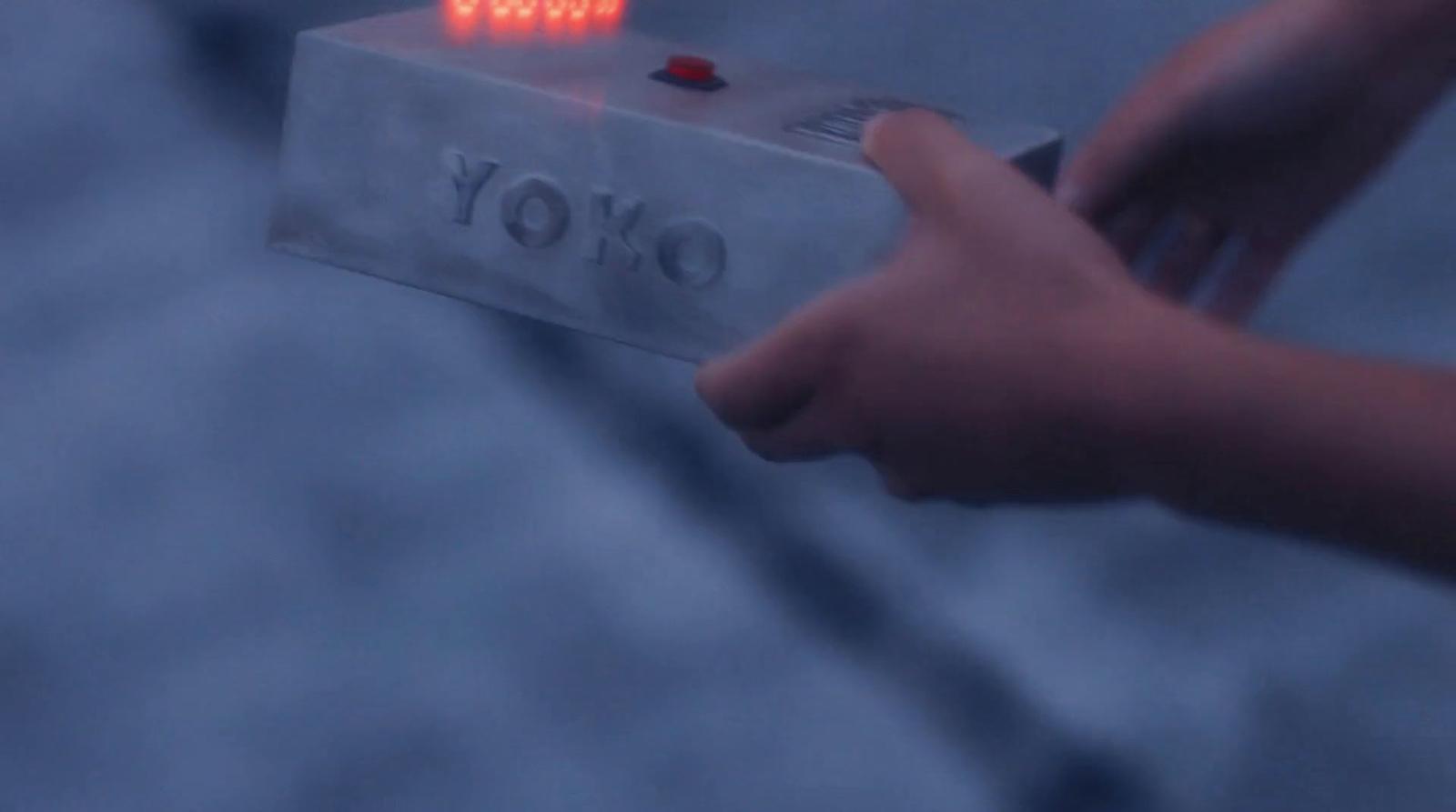 a person holding a small electronic device with a red light on it