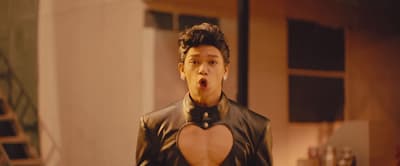 a man in a leather outfit making a funny face