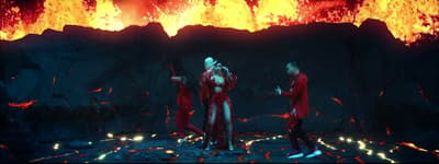 a group of people standing in front of a fire