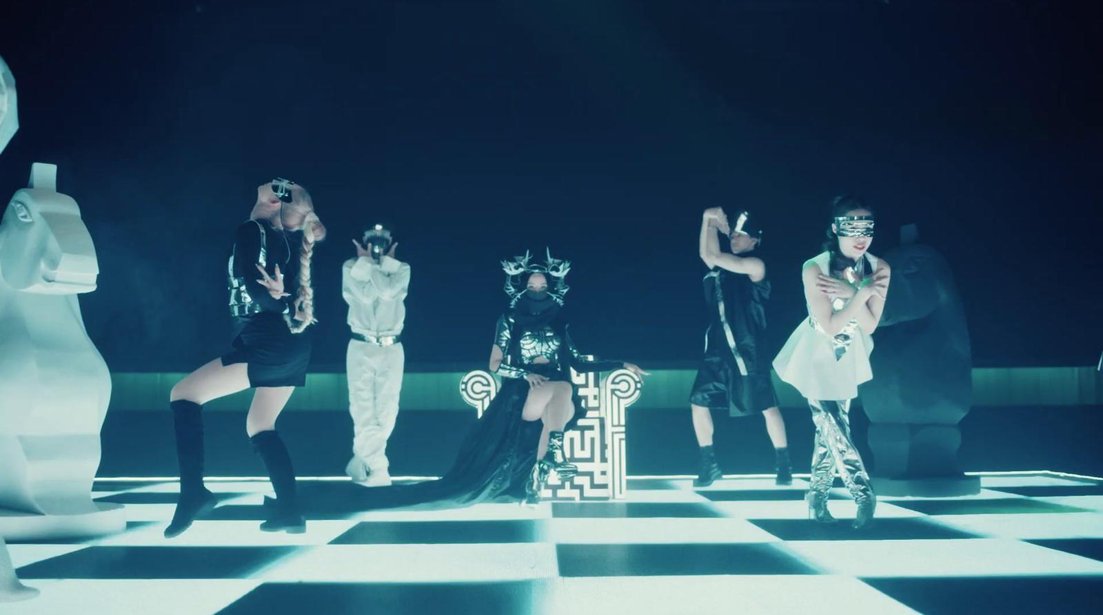 a group of people standing on top of a checkered floor