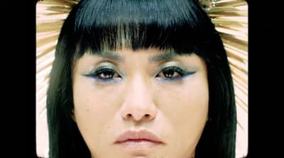 a close up of a person wearing a head piece