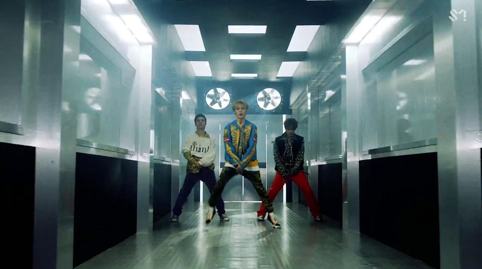 a group of people standing in a hallway