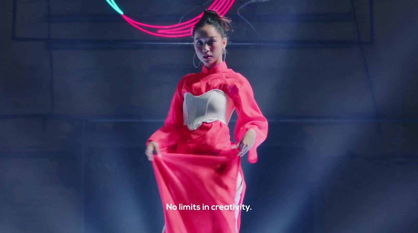 a woman in a pink dress is dancing on stage