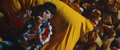 a man laying in a pile of candy