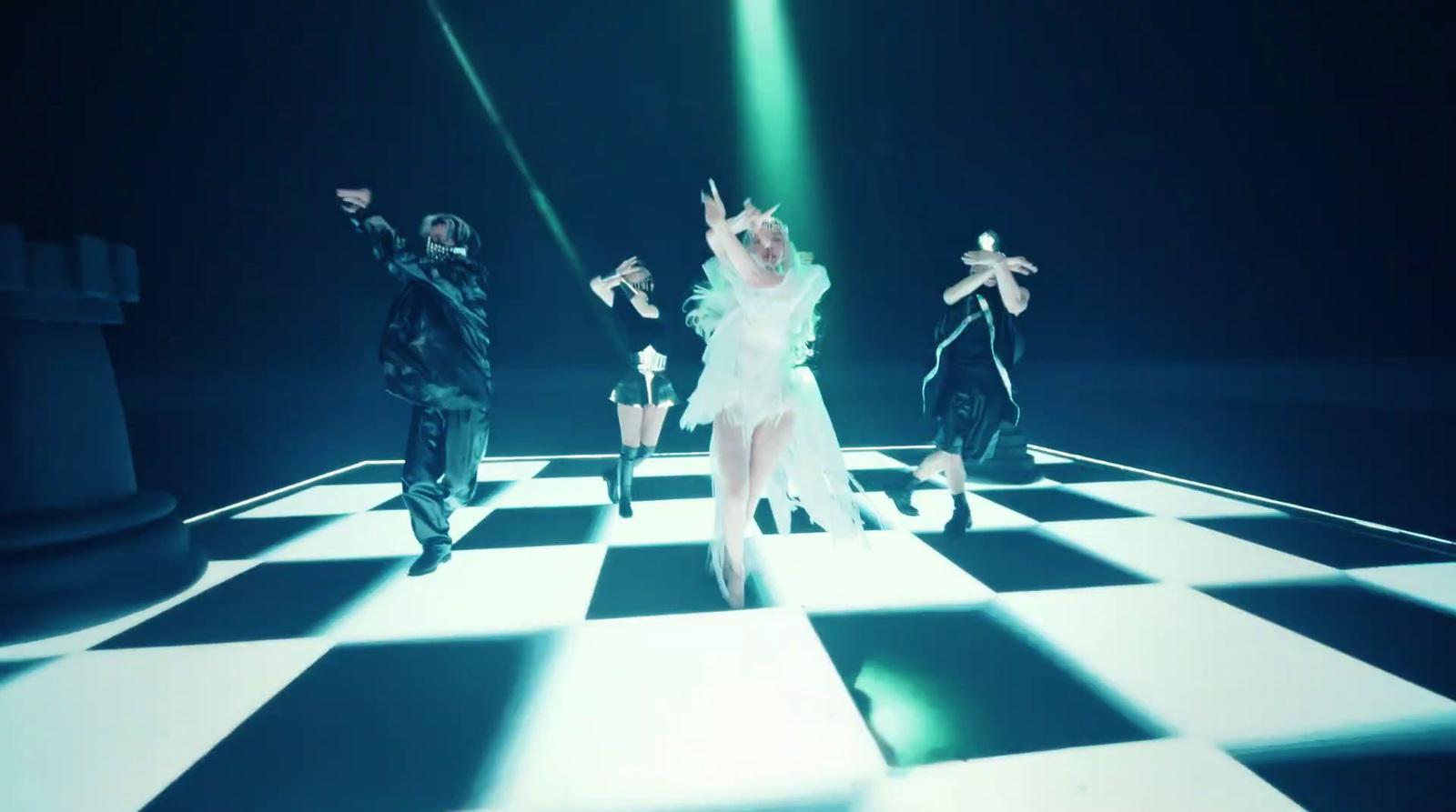 a group of people that are standing on a checkered floor