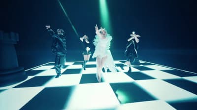 a group of people that are standing on a checkered floor