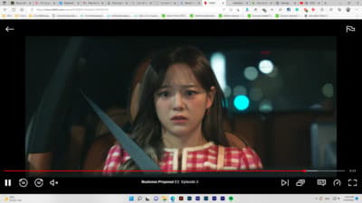a young girl holding a pair of scissors in front of her face