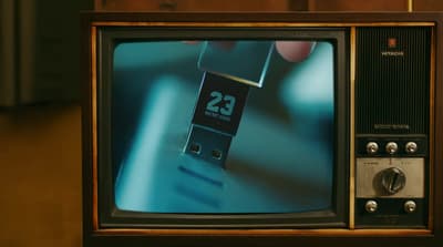 a small television with a small clock on it