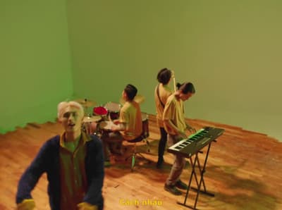 a group of people standing around a musical instrument