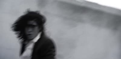 a blurry photo of a man in a suit and tie