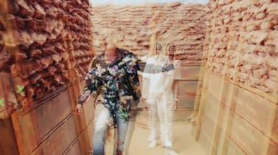 a man and a woman walking down a hallway