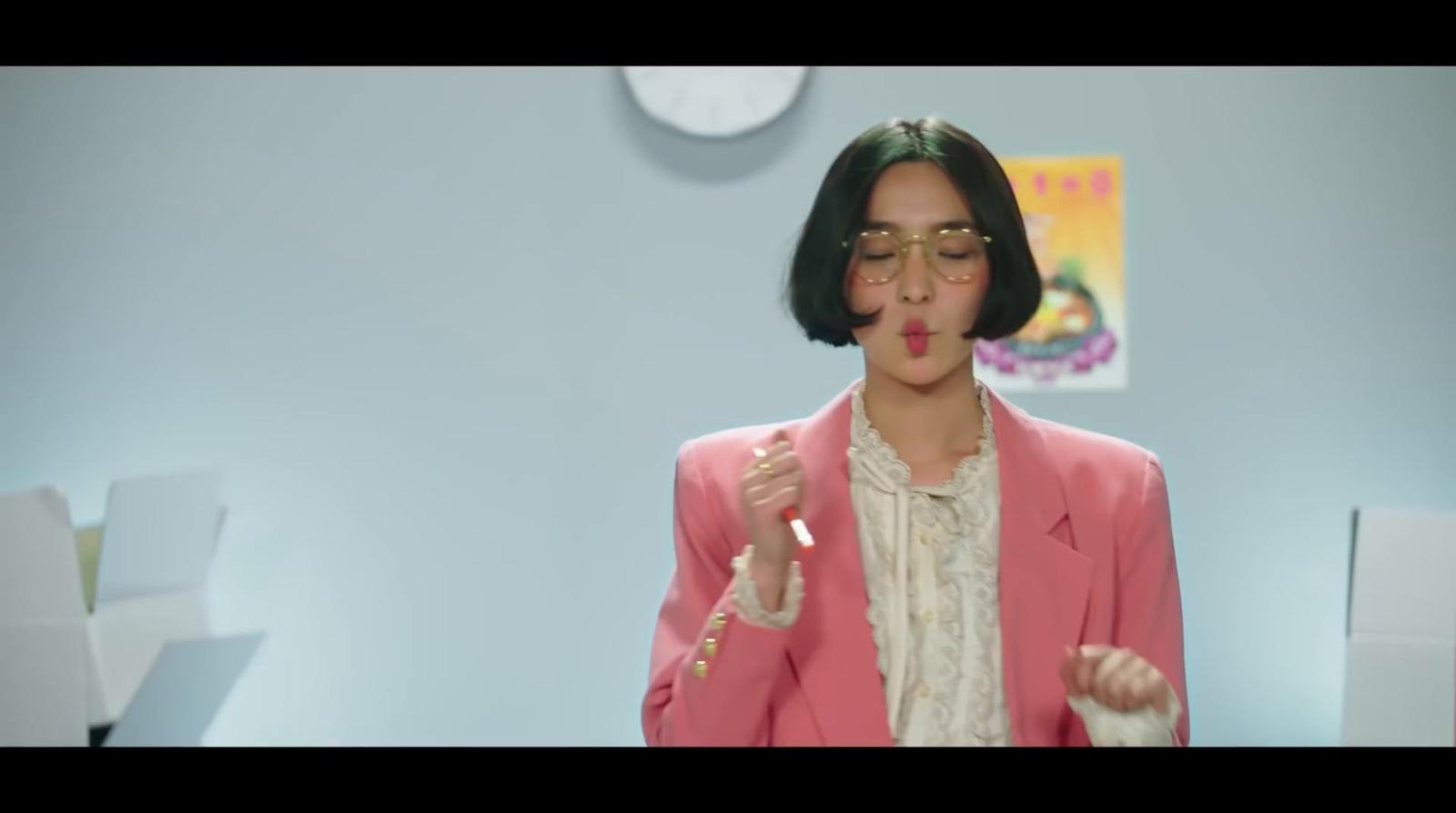 a woman wearing a pink jacket and glasses