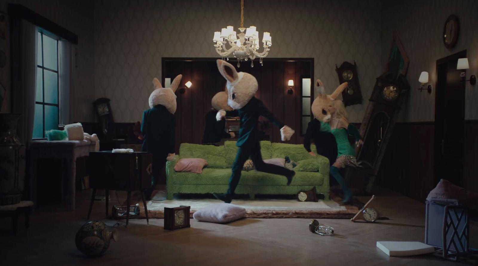a group of people in bunny ears jumping on a couch