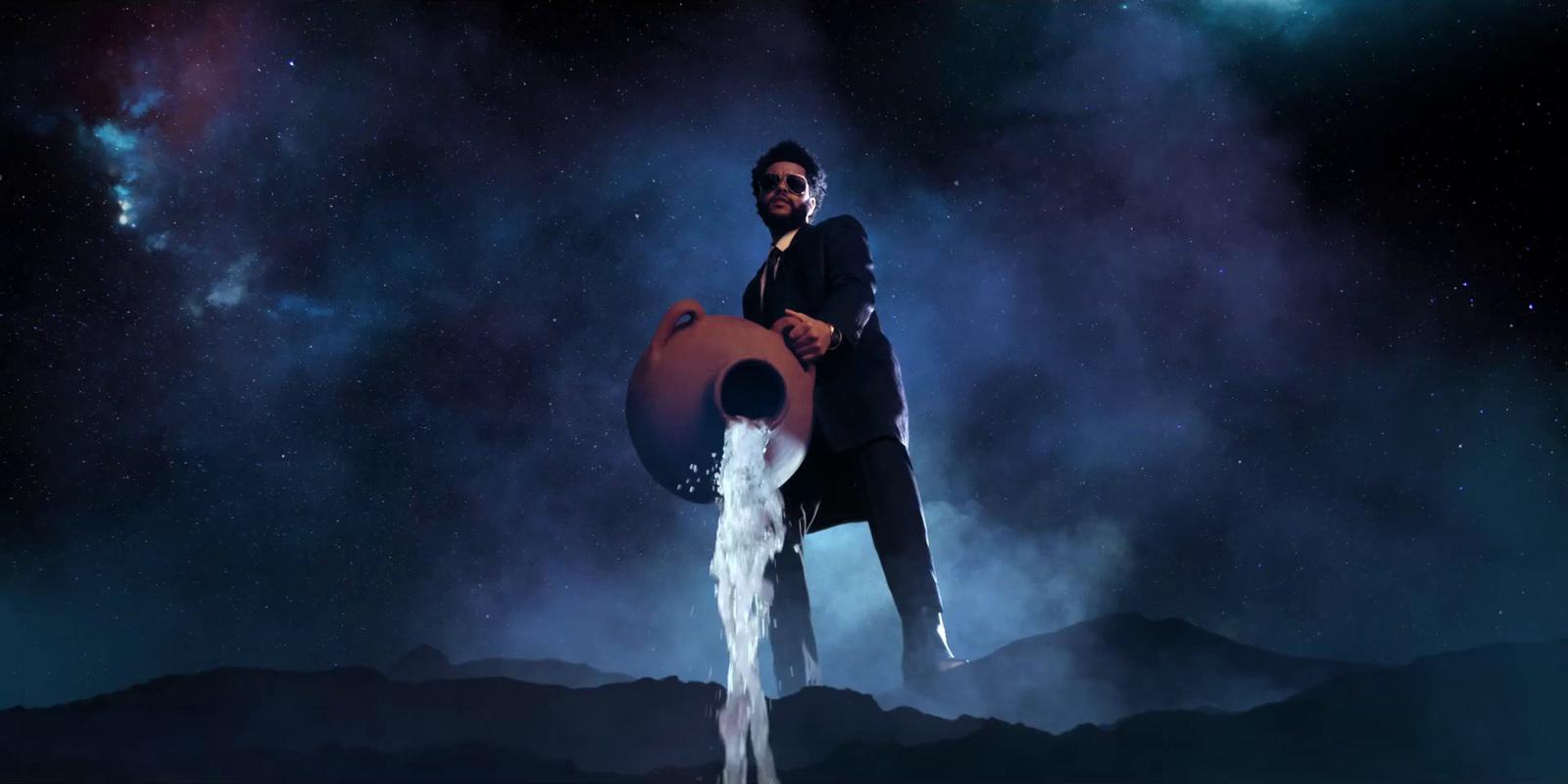 a man standing on top of a mountain holding a large object