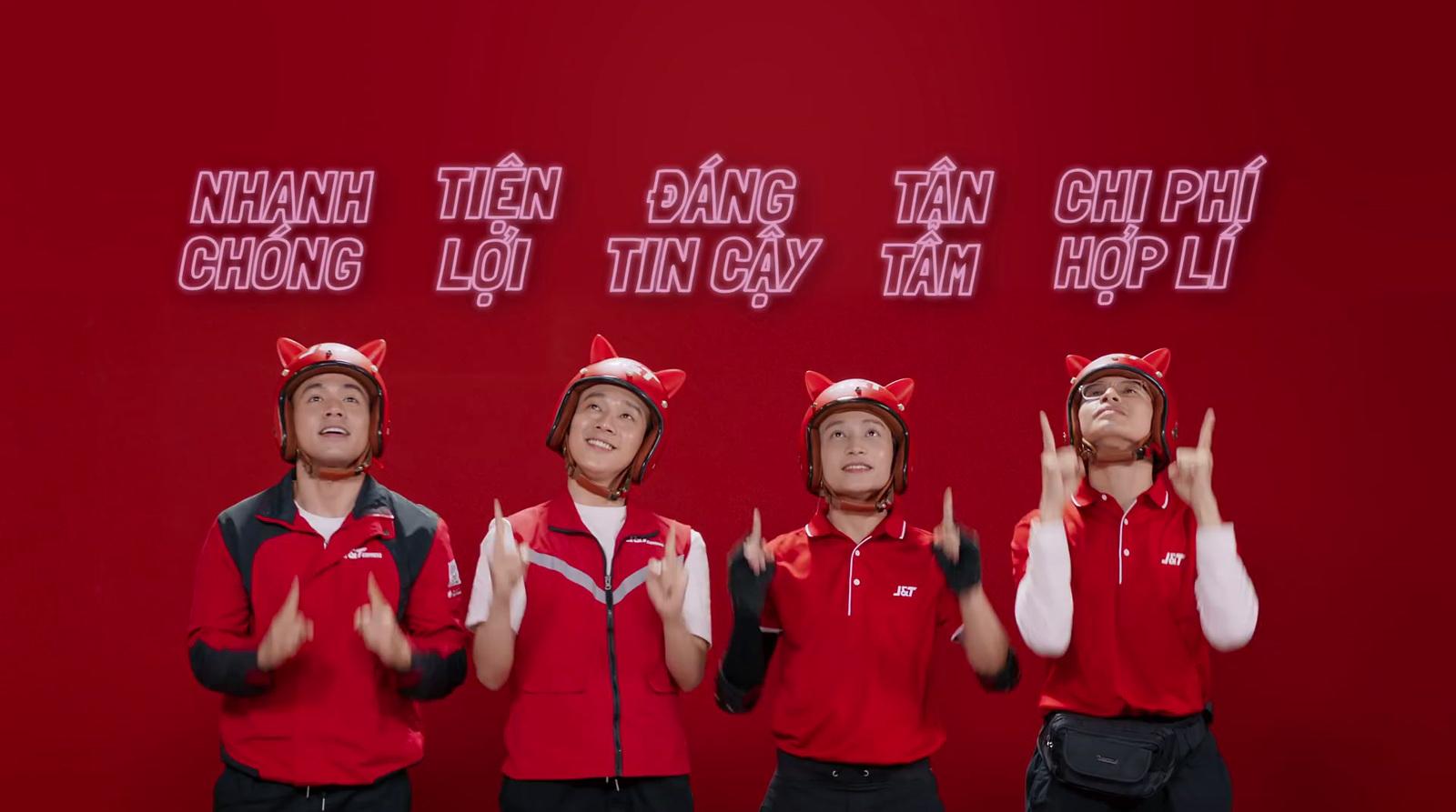 a group of men standing next to each other in front of a red wall