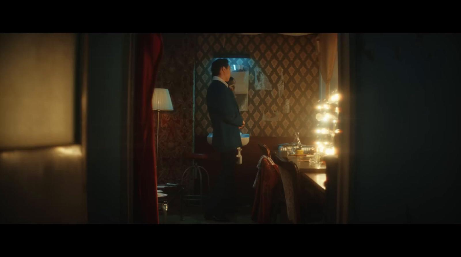 a man in a suit standing in a room