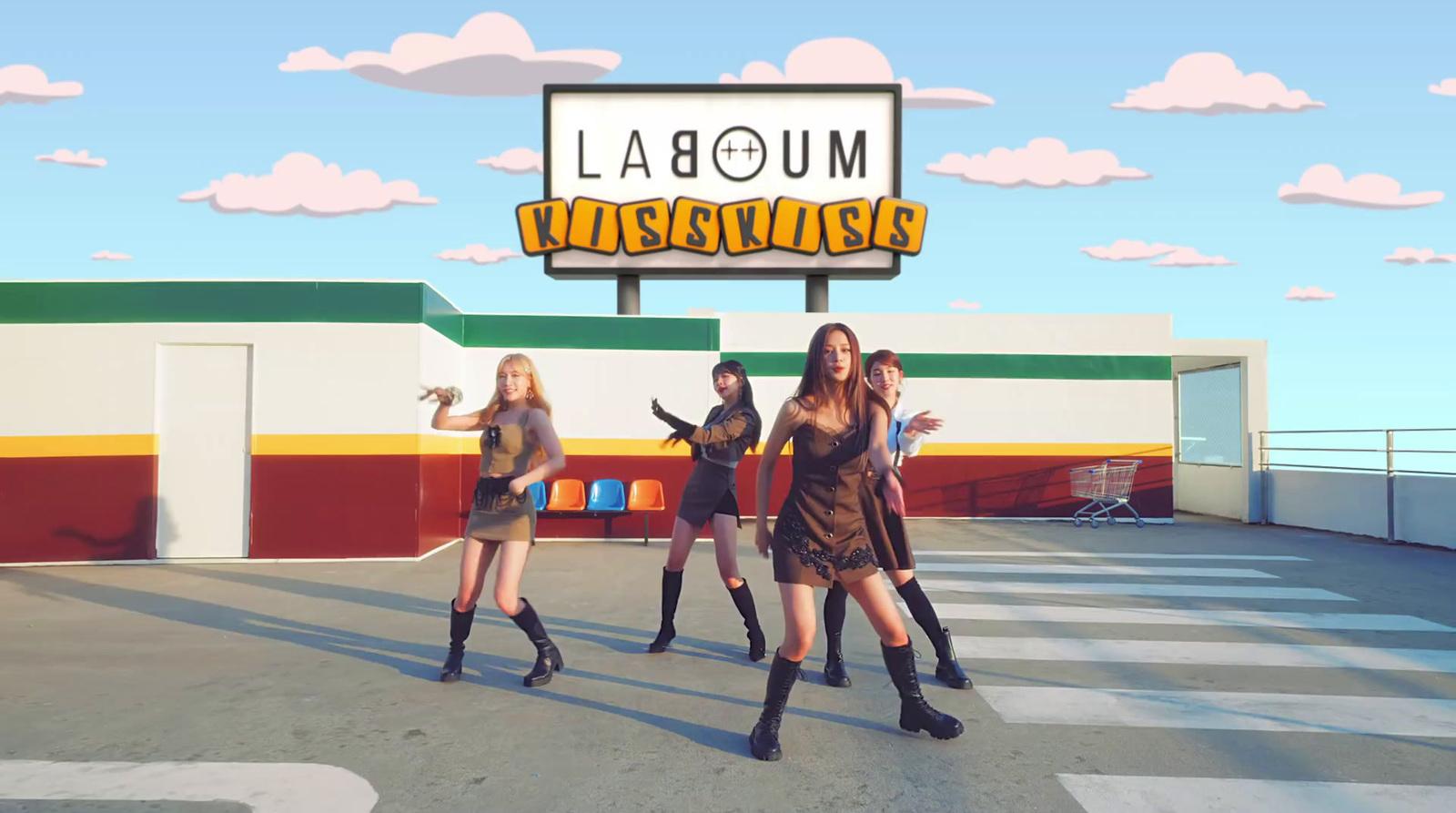 a group of young women dancing in front of a sign