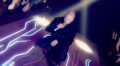 a woman in a black dress on a stage