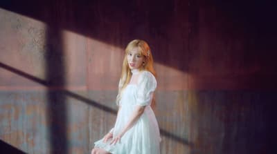 a woman in a white dress posing for a picture