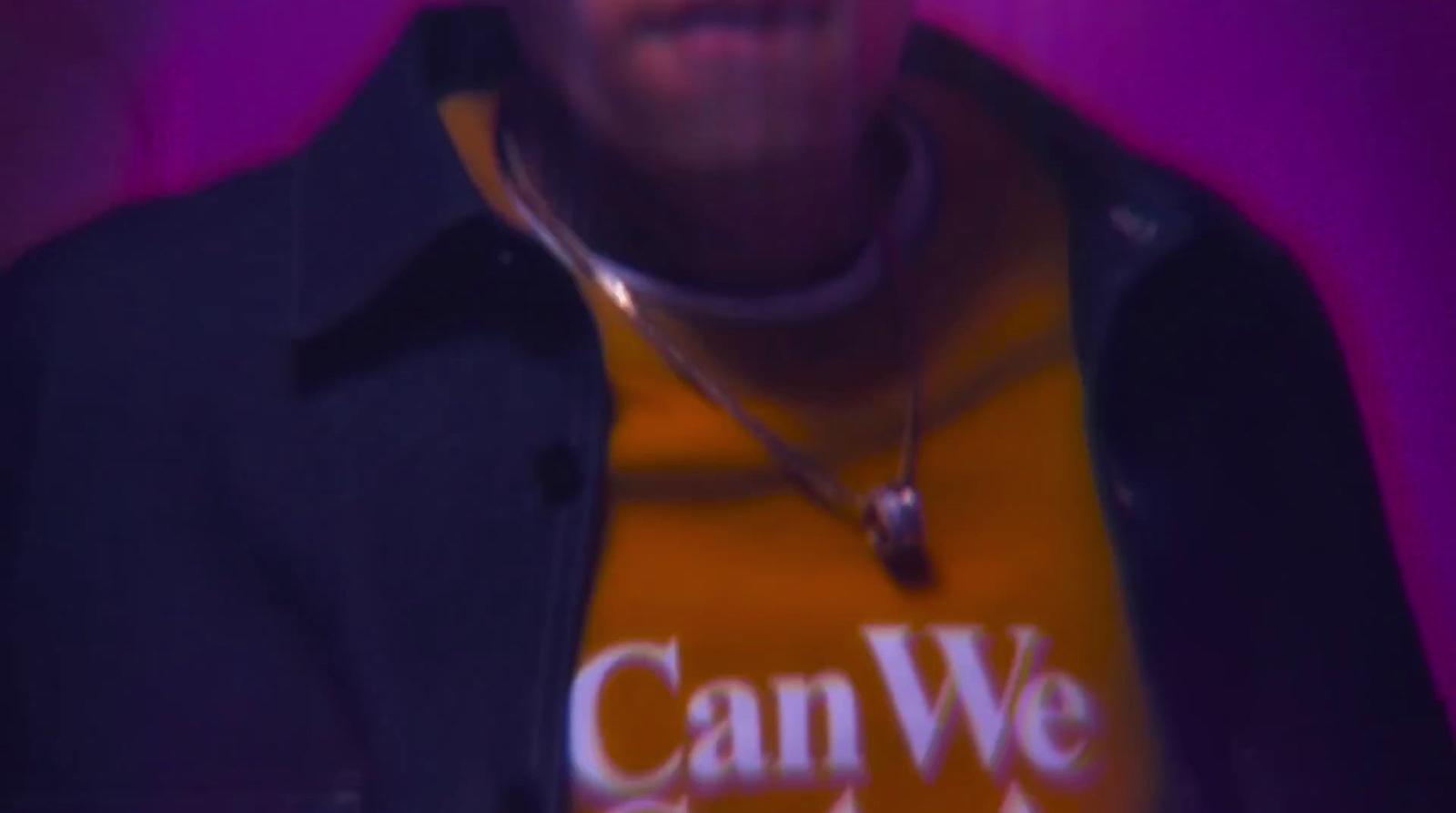 a man wearing a t - shirt that says can we dance?