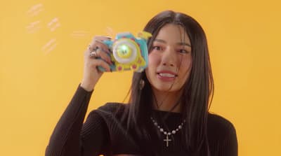 a woman holding a toy in front of her face