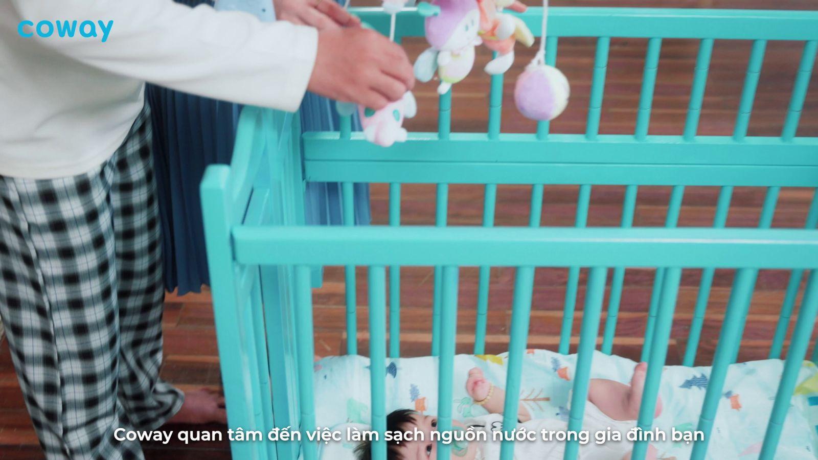 a person putting stuffed animals in a crib