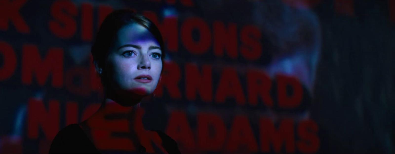 a woman standing in front of a dark background