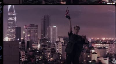 a person holding a cell phone up in the air