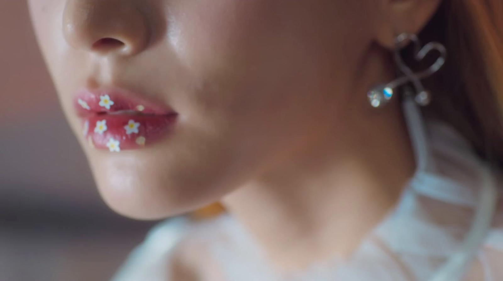 a close up of a woman wearing earrings