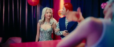 a man and a woman standing in front of a mirror