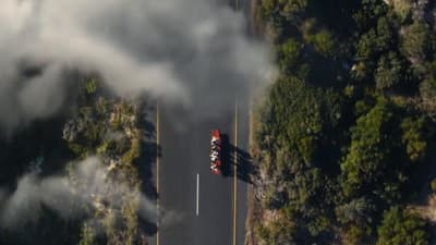 an aerial view of a street with smoke coming out of it
