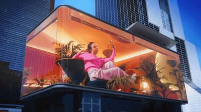 a woman sitting in a chair on top of a building