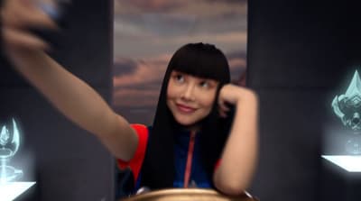a woman with black hair and a red shirt