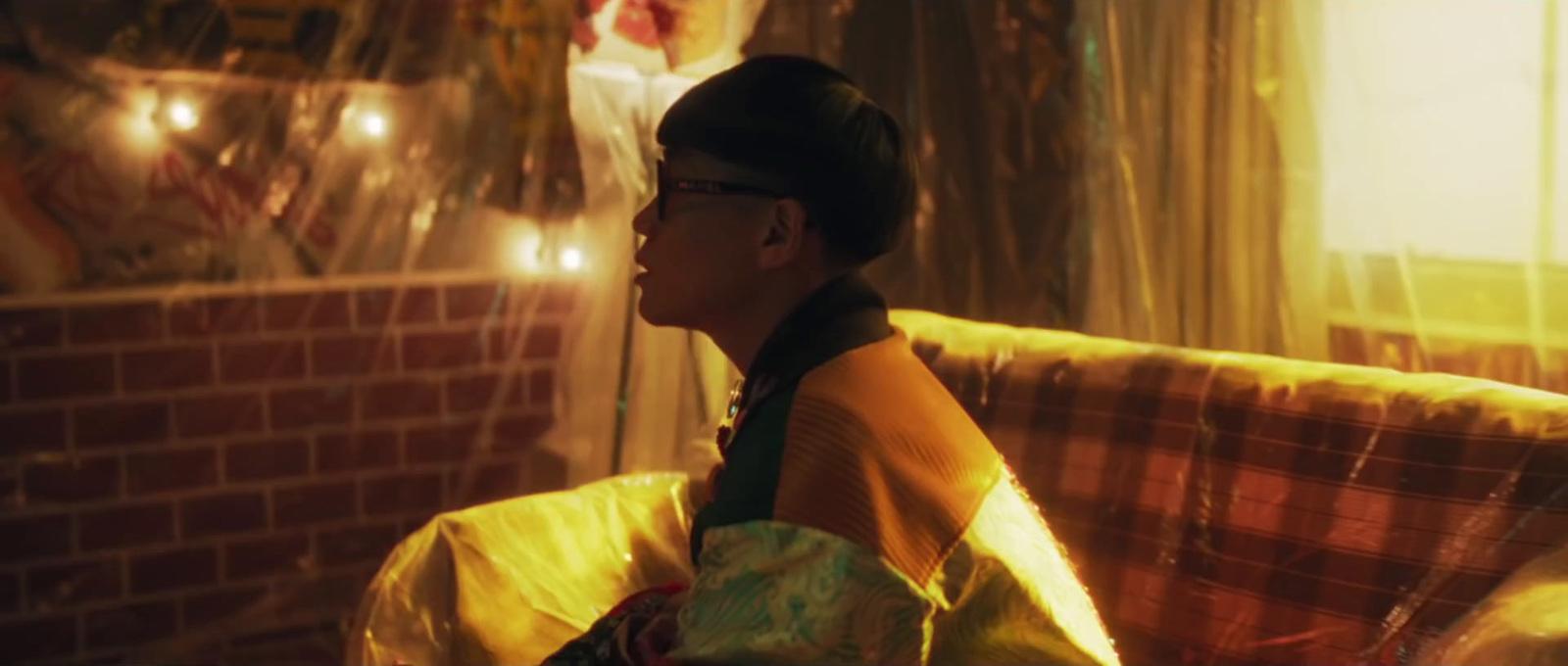 a woman sitting on top of a couch next to a window