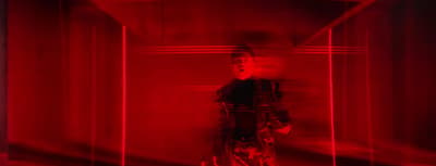a man standing in a room with a red light
