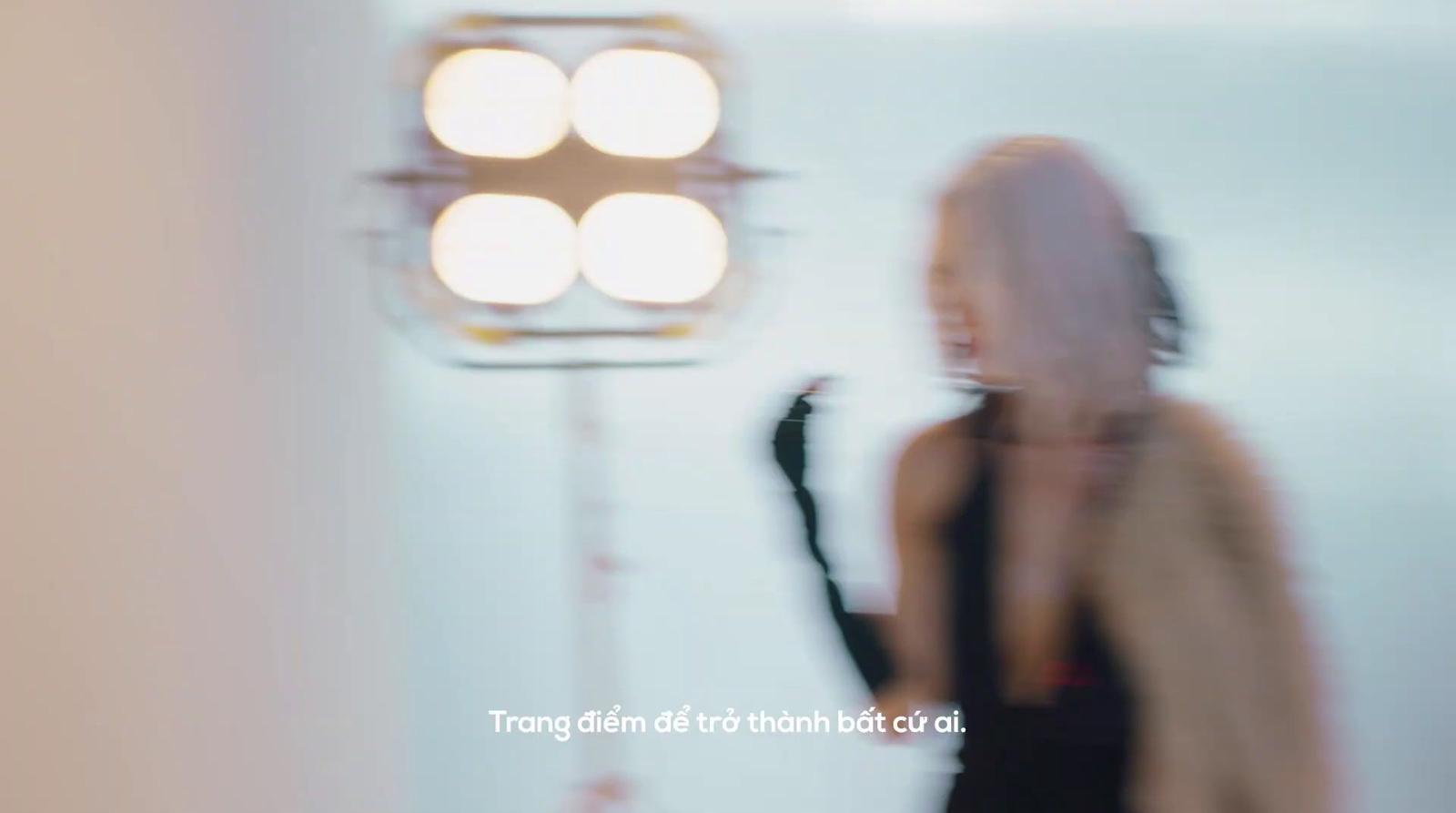 a blurry photo of a woman standing in front of a light