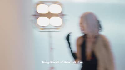 a blurry photo of a woman standing in front of a light