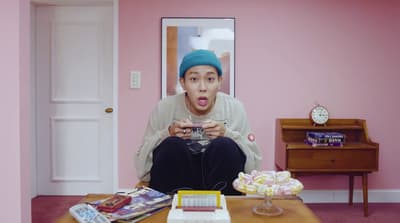 a man sitting on a coffee table holding a camera