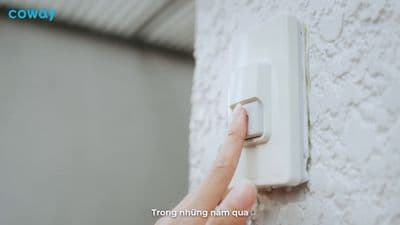 a person turning on a light switch on a wall