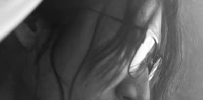 a close up of a person wearing glasses