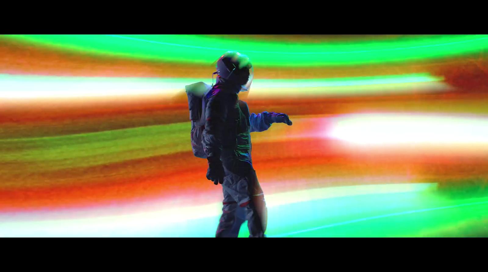 a man standing in front of a colorful background