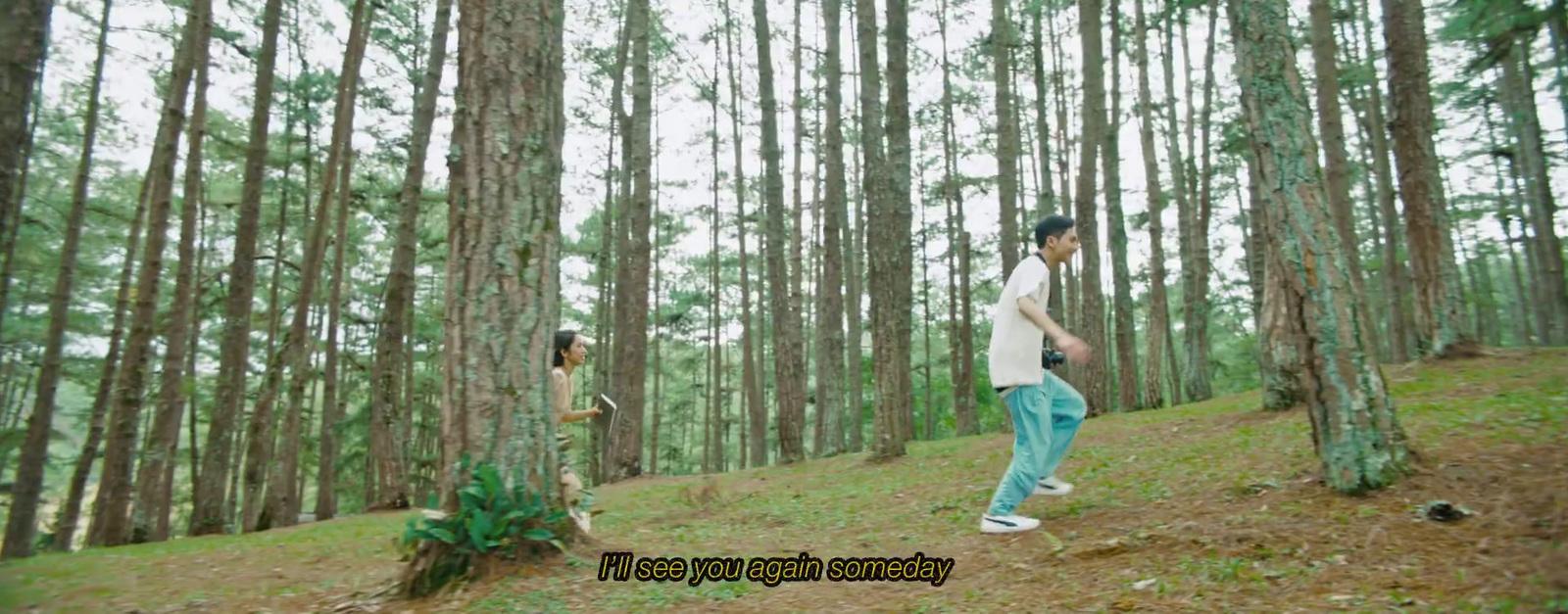 a man and a woman walking through a forest