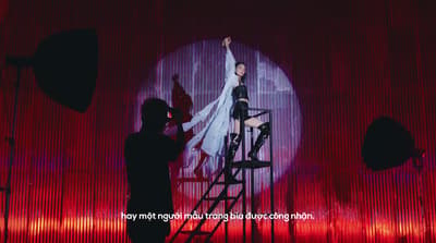 a woman standing on a stage with a microphone
