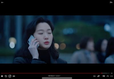 a woman holding a cell phone to her ear