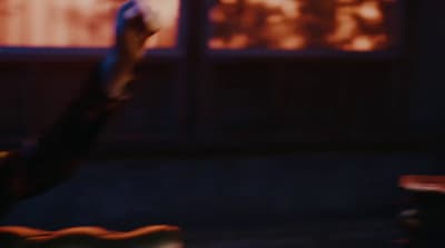 a blurry image of a person holding a remote control