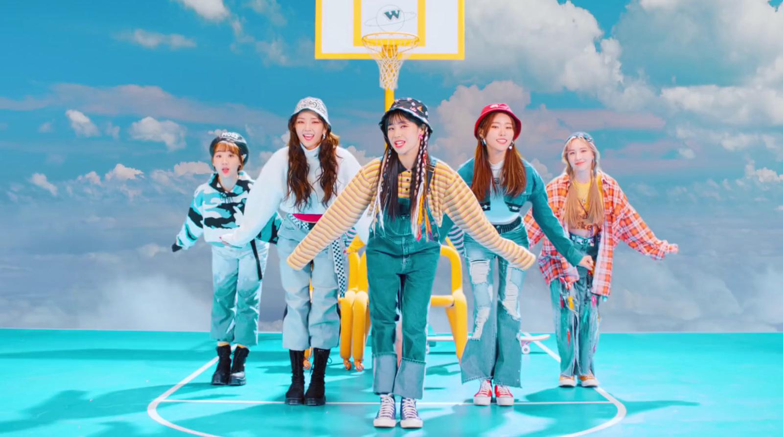 a group of young women standing on top of a basketball court
