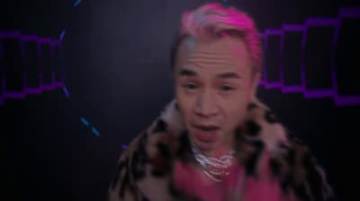 a man with pink hair is making a face
